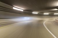 speeding through the tunnel on a highway in motion with blurry background, with light beam above it