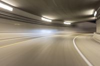 speeding through the tunnel on a highway in motion with blurry background, with light beam above it