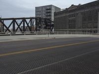a bridge with a bicycle that is attached to it and buildings and street lights on top of it