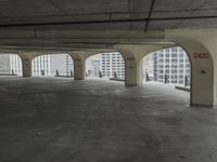 a parking garage with concrete floors and large windows that have painted white over them and red writing