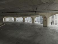 a parking garage with concrete floors and large windows that have painted white over them and red writing