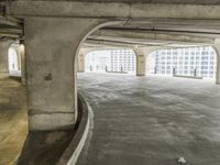 a parking garage with concrete floors and large windows that have painted white over them and red writing