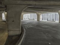 a parking garage with concrete floors and large windows that have painted white over them and red writing