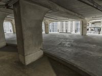 a parking garage with concrete floors and large windows that have painted white over them and red writing