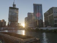 this photo shows the river and buildings in a city skylined by a construction crane