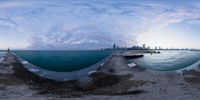 this is an image of the view from a pier and into the ocean with some clouds over the water