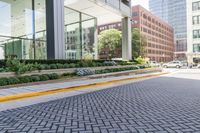 view of the sidewalk outside an office building with a fire hydrant on it in the center of the road