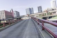 cars and trucks are driving along the freeway in front of a large city skyline while it stretches across a street