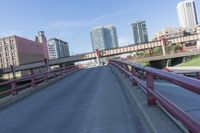 cars and trucks are driving along the freeway in front of a large city skyline while it stretches across a street