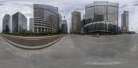 a round image of a modern city with skyscrapers and a person skateboarding on the road