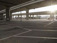 an empty parking lot in the sun, with the lights on the roof reflecting off of it