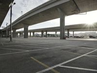 an empty parking lot in the sun, with the lights on the roof reflecting off of it