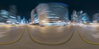 a blurry image of some tall buildings on a night time beach area in the ocean