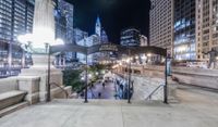 people walking through a city center at night with a large sign in the background that reads hotel york