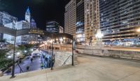 people walking through a city center at night with a large sign in the background that reads hotel york