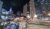 people walking through a city center at night with a large sign in the background that reads hotel york