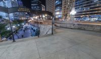 people walking through a city center at night with a large sign in the background that reads hotel york