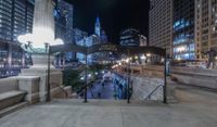 people walking through a city center at night with a large sign in the background that reads hotel york