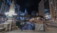 people walking through a city center at night with a large sign in the background that reads hotel york