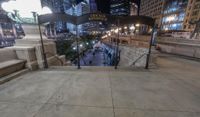 people walking through a city center at night with a large sign in the background that reads hotel york