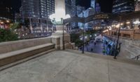 people walking through a city center at night with a large sign in the background that reads hotel york