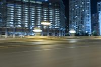 a photo of buildings from a moving car that is moving through the picture, in motion