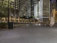 a city street filled with tall buildings and buildings next to a river and a walkway