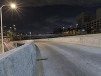 this is a shot of a person on a skateboard on a bridge at night