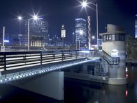 a view of the lights from the bridge on a dark night in a city with its bridge open