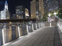 people walking on a bridge near some buildings by the river at night under a full moon