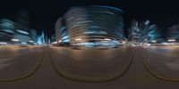 blurry photo of a cityscape of skyscrapers and a street at night