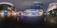 the view of an intersection from the corner looking down at a few buildings with light streaks on the tops