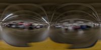 several cars in the middle of a large parking garage area with long exposure lines on them