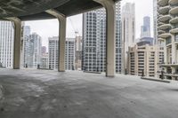 a bike parked next to tall buildings in a parking lot near an overpass overlooking a city