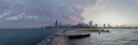 the view of chicago skyline as seen from across a body of water at sunset with the city in the background