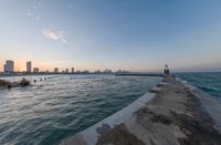 an expanse of water and sea with a cityscape in the distance with a building on one of them