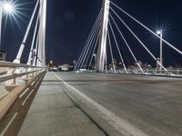 a view from a bridge across the city at night, looking down towards a city