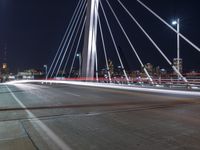 a view from a bridge across the city at night, looking down towards a city