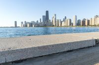 a large body of water with a city skyline behind it in the background's foreground