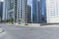 a city filled with lots of tall buildings on top of a gray concrete floor underneath blue sky