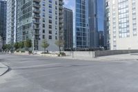 a city filled with lots of tall buildings on top of a gray concrete floor underneath blue sky