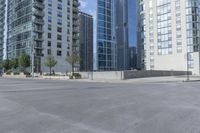 a city filled with lots of tall buildings on top of a gray concrete floor underneath blue sky