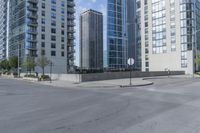 a city filled with lots of tall buildings on top of a gray concrete floor underneath blue sky