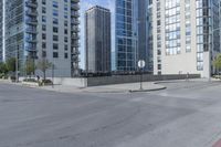 a city filled with lots of tall buildings on top of a gray concrete floor underneath blue sky