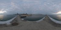 a view of the skyline over water and dock in chicago at sunrise time, as seen through a fish eye lens