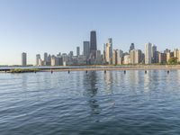 view of the skyline and water in a lake with people kayaking and paddleboarding