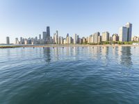 view of the skyline and water in a lake with people kayaking and paddleboarding