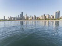 view of the skyline and water in a lake with people kayaking and paddleboarding