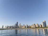 view of the skyline and water in a lake with people kayaking and paddleboarding