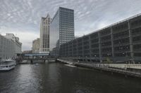 a boat travels down a river as several buildings line the sides of the canal near a dock